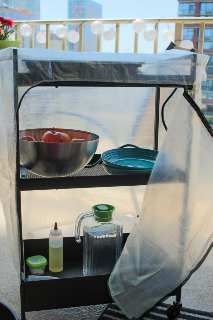 Rain and dust cover for the tiny outdoor kitchen: an Ikea Hyllis clear cover