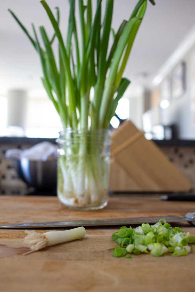 Keep scallions in water to keep them fresh