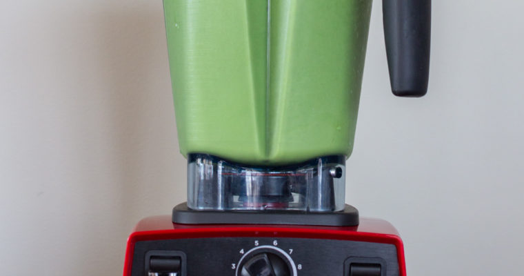 Blending a green smoothie in a red Vitamix 5300