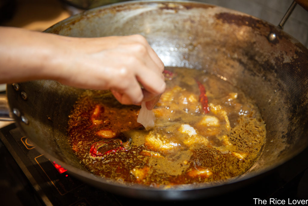 Sliced fish fillets going into Sichuan spicy boiled fish broth