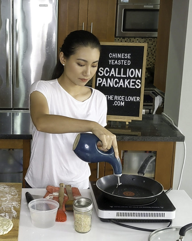 Pouring oil out of the Rachael Ray oil dispenser, marine blue