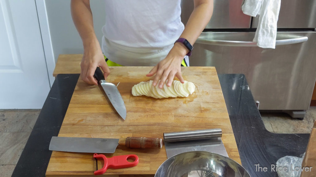 Fan out the potato slices like a deck of cards to form an event, flat layer