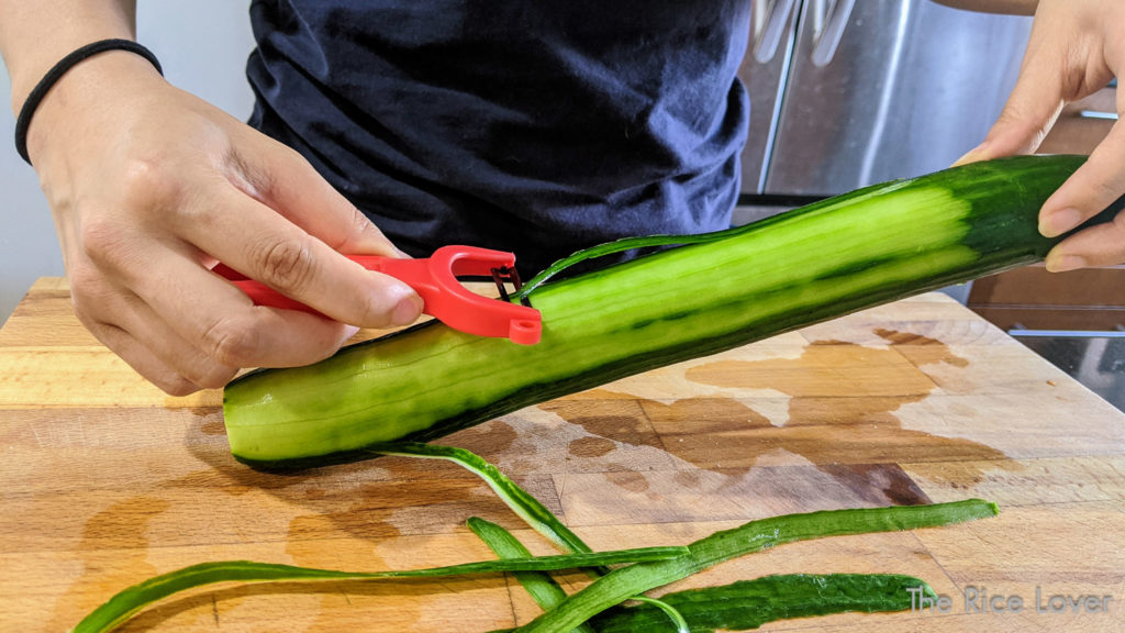 using Kuhn Rikon Swiss peeler to peel a cucumber
