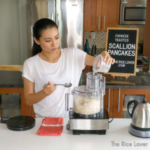 Add yeast and water to the food processor and run it until the dough forms a ball