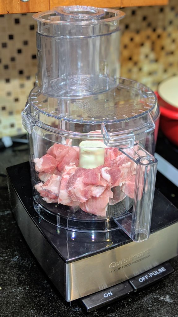 Place cubed pork shoulder in the food processor